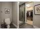 Modern bathroom with toilet, stone-accented shower, and partial view into the walk-in closet with shelves at 635 S Orange Ave # 404, Sarasota, FL 34236