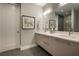 Well-lit bathroom featuring a dual sink vanity, sleek cabinets, modern fixtures, and a walk-in shower at 635 S Orange Ave # 404, Sarasota, FL 34236