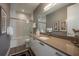 Sleek bathroom with a modern vanity, framed mirror, and a glass-enclosed shower/tub at 635 S Orange Ave # 404, Sarasota, FL 34236