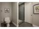 Nicely tiled bathroom with a toilet and shower, with a glimpse of the walk-in closet at 635 S Orange Ave # 404, Sarasota, FL 34236