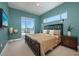 Modern bedroom with beautiful teal walls, a large window with a view, and contemporary decor at 635 S Orange Ave # 404, Sarasota, FL 34236