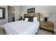 Comfortable bedroom boasts a decorative headboard, stylish nightstands, and a relaxing ensuite bathroom at 635 S Orange Ave # 404, Sarasota, FL 34236