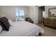 Cozy bedroom featuring a comfortable bed, large window, and view of the neighborhood at 635 S Orange Ave # 404, Sarasota, FL 34236