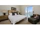 Comfortable bedroom with a large bed, stylish bedside tables, and a sunny window at 635 S Orange Ave # 404, Sarasota, FL 34236