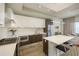 Bright, modern kitchen boasts stainless steel appliances, sleek cabinets, and an island with counter seating at 635 S Orange Ave # 404, Sarasota, FL 34236