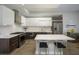 Contemporary kitchen with a gas range, stainless appliances, and a quartz island with bar stool seating at 635 S Orange Ave # 404, Sarasota, FL 34236