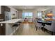 Open-concept layout with living area, dining space, and kitchen bar, with outdoor views at 635 S Orange Ave # 404, Sarasota, FL 34236