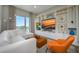 Modern living room with large windows, a white sectional, and a built-in entertainment center at 635 S Orange Ave # 404, Sarasota, FL 34236