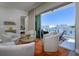 Comfortable seating area flows to the outdoor balcony with views of the community and sky at 635 S Orange Ave # 404, Sarasota, FL 34236