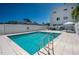 Community pool with sun loungers and an umbrella at 635 S Orange Ave # 404, Sarasota, FL 34236
