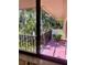 Condo balcony overlooking lush tropical landscaping and palm trees, offering privacy at 6450 Wild Oak Bay Blvd # 240, Bradenton, FL 34210