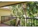 Balcony view overlooking lush palm trees and tropical landscaping at 6450 Wild Oak Bay Blvd # 240, Bradenton, FL 34210