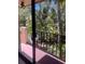 View from condo balcony overlooking lush tropical landscaping with swaying palms, offering serenity at 6450 Wild Oak Bay Blvd # 240, Bradenton, FL 34210
