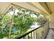 Balcony view showcasing a tranquil pond with a fountain, lush greenery, and mature trees at 6450 Wild Oak Bay Blvd # 240, Bradenton, FL 34210