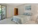 Bright bedroom with balcony access features a closet and decorative sailboat artwork at 6450 Wild Oak Bay Blvd # 240, Bradenton, FL 34210