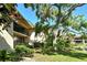 Condominium exterior with tan stucco, black railings, and lush landscaping at 6450 Wild Oak Bay Blvd # 240, Bradenton, FL 34210