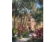 Condo exterior featuring mature tropical landscaping and pathway to front door at 6450 Wild Oak Bay Blvd # 240, Bradenton, FL 34210