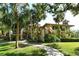 Condominium exterior with tan stucco, red tile roof, and lush landscaping at 6450 Wild Oak Bay Blvd # 240, Bradenton, FL 34210