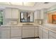 Bright kitchen with white countertops and white cabinets, stainless steel sink, and a garden view at 6450 Wild Oak Bay Blvd # 240, Bradenton, FL 34210