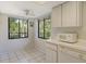 Bright eat-in kitchen features white cabinets, appliances, and windows offering a lush green view at 6450 Wild Oak Bay Blvd # 240, Bradenton, FL 34210