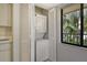Laundry area with stacked washer and dryer, a window overlooking a green view, and storage at 6450 Wild Oak Bay Blvd # 240, Bradenton, FL 34210
