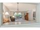 View of the living room from the kitchen with a neutral color scheme, comfortable seating, and a screened porch at 6450 Wild Oak Bay Blvd # 240, Bradenton, FL 34210