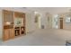 Bright living room featuring a wooden display case and neutral carpeting throughout at 6450 Wild Oak Bay Blvd # 240, Bradenton, FL 34210