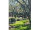 Park with a bench surrounded by lush trees and landscaping with a small stream at 6450 Wild Oak Bay Blvd # 240, Bradenton, FL 34210