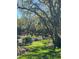 Park with a bench surrounded by mature trees and landscaping with a small stream at 6450 Wild Oak Bay Blvd # 240, Bradenton, FL 34210