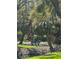 Picturesque park setting with a bench surrounded by mature trees and lush landscaping at 6450 Wild Oak Bay Blvd # 240, Bradenton, FL 34210