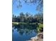 Pond with tree reflections, surrounded by lush landscaping, creating a serene community at 6450 Wild Oak Bay Blvd # 240, Bradenton, FL 34210