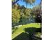 Scenic view of a lush pond with a fountain, framed by trees and greenery in a serene outdoor setting at 6450 Wild Oak Bay Blvd # 240, Bradenton, FL 34210