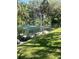 Picturesque pond featuring a water fountain and bordered by mature trees and green grass at 6450 Wild Oak Bay Blvd # 240, Bradenton, FL 34210