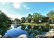 Scenic view of a community pond with fountain and lush surroundings at 6450 Wild Oak Bay Blvd # 240, Bradenton, FL 34210
