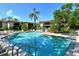Community pool featuring a hot tub, lounge chairs and tropical landscaping at 6450 Wild Oak Bay Blvd # 240, Bradenton, FL 34210