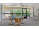 Screened-in porch with dining table and ceiling fan at 6450 Wild Oak Bay Blvd # 240, Bradenton, FL 34210
