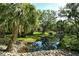Serene view of a community stream surrounded by tropical landscaping at 6450 Wild Oak Bay Blvd # 240, Bradenton, FL 34210