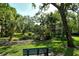 Scenic view of a community stream and lush landscaping from a park bench at 6450 Wild Oak Bay Blvd # 240, Bradenton, FL 34210