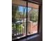 View from condo window overlooking lush tropical landscaping with swaying palms at 6450 Wild Oak Bay Blvd # 240, Bradenton, FL 34210