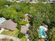 Aerial view showcasing the property's pool, surrounding landscape and other nearby homes at 6905 Arbor Oaks Ct, Bradenton, FL 34209