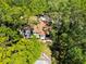 An aerial perspective highlights the home's roof, windows, and backyard, all embraced by mature trees at 6905 Arbor Oaks Ct, Bradenton, FL 34209