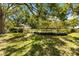 A lush backyard showcases mature trees and landscaping, providing a serene outdoor setting at 6905 Arbor Oaks Ct, Bradenton, FL 34209