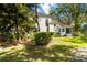 Backyard view with a screened in porch and lush landscaping at 6905 Arbor Oaks Ct, Bradenton, FL 34209