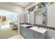 Modern bathroom with double vanity, stylish tile work, and adjoining bedroom views at 6905 Arbor Oaks Ct, Bradenton, FL 34209