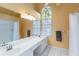 Spacious bathroom with double vanity, shower and tub combo, and large window at 6905 Arbor Oaks Ct, Bradenton, FL 34209
