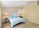 Bright bedroom with ceiling fan, light blue accents and neutral carpet at 6905 Arbor Oaks Ct, Bradenton, FL 34209