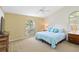 Bedroom featuring a window, a ceiling fan, and a comfortable bed at 6905 Arbor Oaks Ct, Bradenton, FL 34209