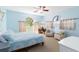 Comfortable bedroom with arched windows, light blue walls, and relaxing sitting area at 6905 Arbor Oaks Ct, Bradenton, FL 34209