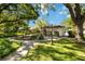 Detached outbuilding with lush green landscaping and walking path at 6905 Arbor Oaks Ct, Bradenton, FL 34209
