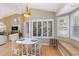 Dining nook with shuttered windows, a round table, and a cozy bench seat beneath a bay window at 6905 Arbor Oaks Ct, Bradenton, FL 34209